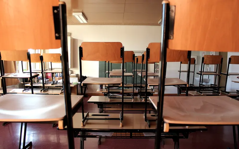 Empty classroom with desks and whiteboard