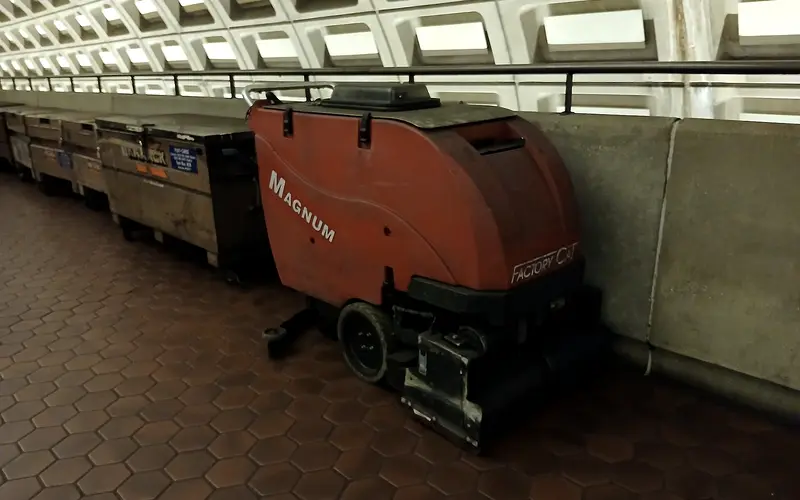 Cleaner working a hard floor in a commercial building