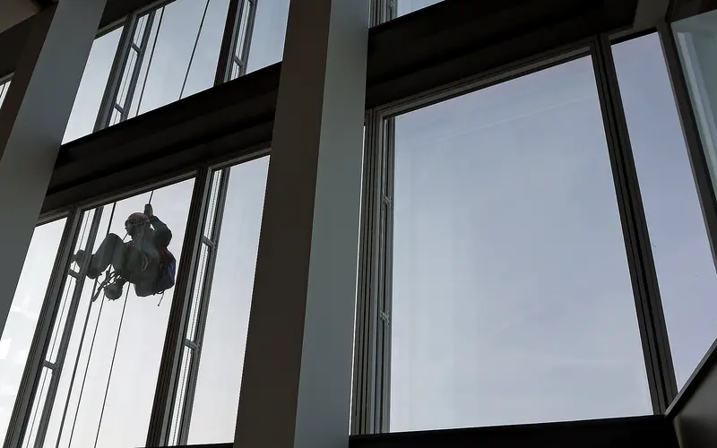 Window cleaner working on commercial building glass